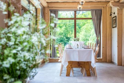 a table with a white table cloth and chairs in a room at Willa Litworówka III Wellness&SPA in Poronin