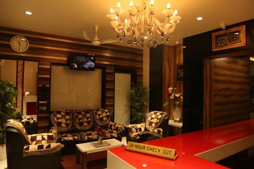 a living room with couches and a chandelier at HOTEL MADNI ROYALE (50 Mtrs from Dargaah), Ajmer in Ajmer