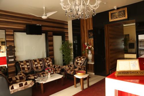 a living room with couches and a chandelier at HOTEL MADNI ROYALE (50 Mtrs from Dargaah), Ajmer in Ajmer