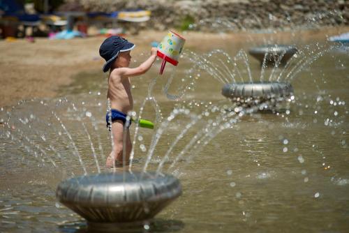 
a young boy in a pool of water with a hose at Liberty Lykia in Oludeniz
