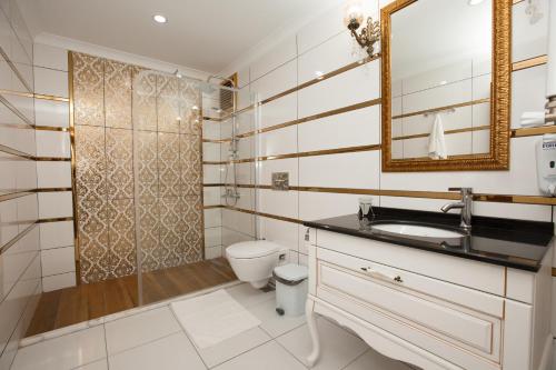 a bathroom with a toilet and a sink and a mirror at North Pearl Residence in Trabzon