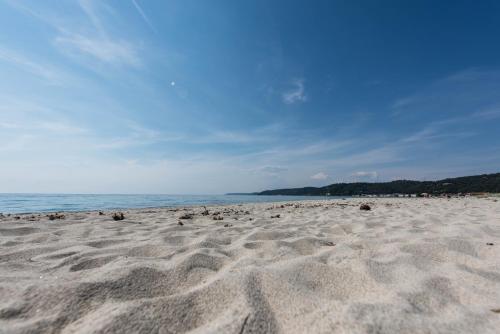 a beach with a lot of sand and the ocean at #Luxlikehome - The Seascape Villa in Skála Foúrkas