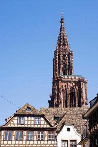 a building with a clock tower in the background at Novotel Strasbourg Centre Halles in Strasbourg