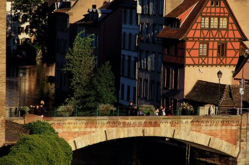 a bridge over a river in a city with buildings at Novotel Strasbourg Centre Halles in Strasbourg