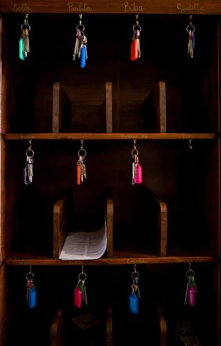a wooden shelf with keys and papers on it at Villa Moorings in Barga