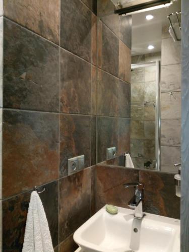 a bathroom with a sink and a mirror at Apartament Slavia Rosa in Międzyzdroje
