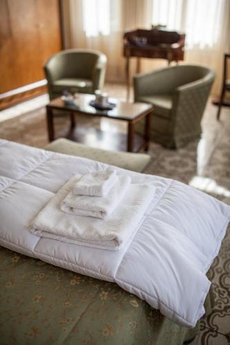 a hotel room with a bed with towels on it at Villa Moorings in Barga
