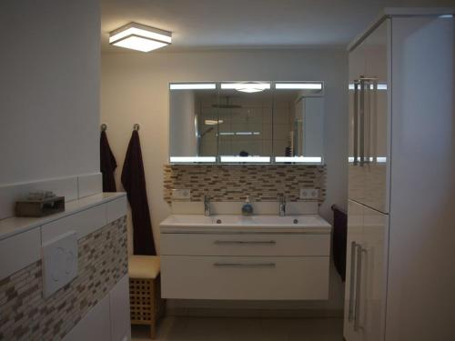 a bathroom with a sink and a mirror at Ferienwohnung Mayer in Albstadt