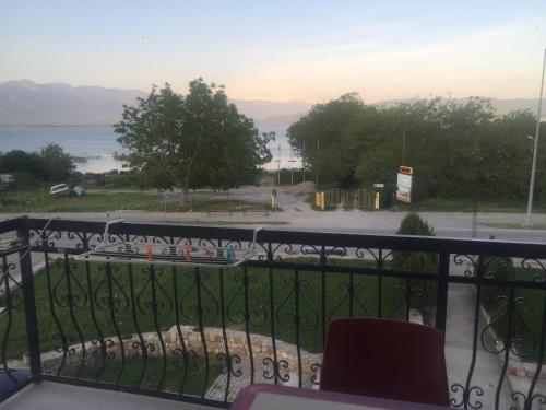a room with a balcony with a view of the water at Apartmani Alex Beach in Star Dojran