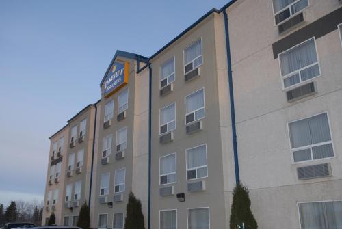 a building with a sign on the side of it at Lakeview Inns & Suites - Fort Saskatchewan in Fort Saskatchewan