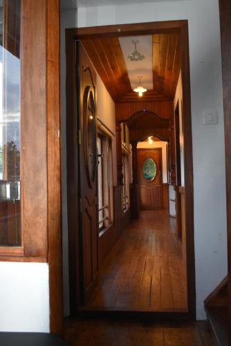 a hallway of a house with a wooden door at Mango Kerala Homes in Kumarakom