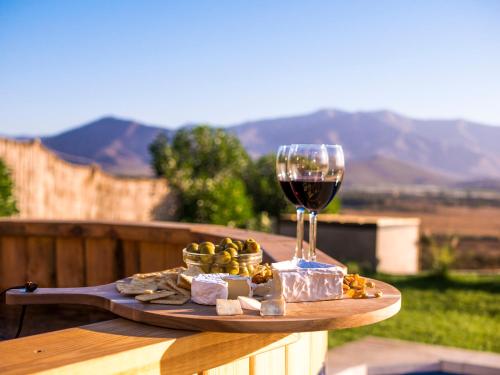 eine Käseplatte und ein Glas Wein auf dem Tisch in der Unterkunft Villas Toscanas in Limache