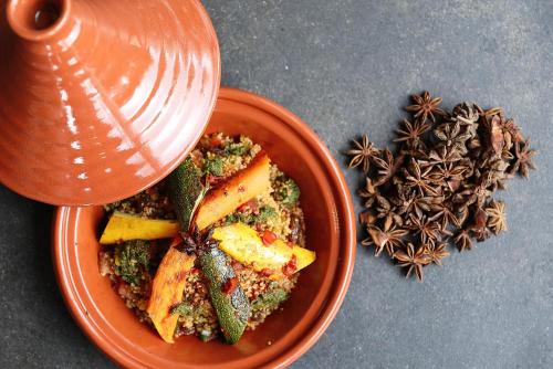 a bowl of food on a table with a drink at Hotel du Vin Cheltenham in Cheltenham