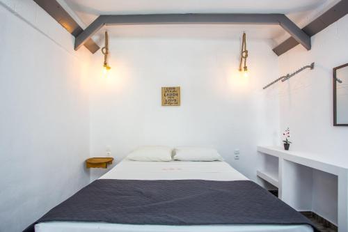a bedroom with a bed in a white room at Toula's Apartments in Faliraki