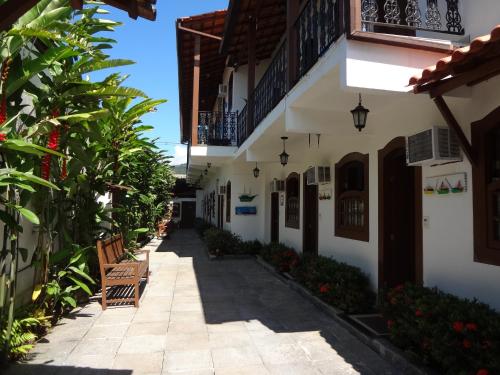 an alley in a house with benches at Pousada Doce Paraty in Paraty
