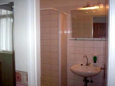 a bathroom with a sink and a mirror at Hotel Flóra** in Orosháza