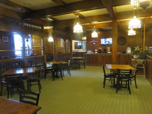 a restaurant with tables and chairs and a bar at Baymont by Wyndham Fargo in Fargo