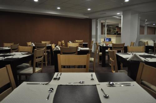 an empty dining room with tables and chairs and tablesktop at Green Life Family Apartments Pamporovo in Pamporovo
