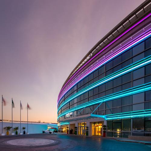 an office building with purple and blue lights at Park Inn by Radisson Dubai Motor City in Dubai