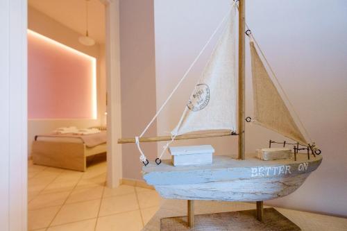 a wooden boat on display in a room at Cozy Home steps from old Port, Seafront & Parking in Kolymvari