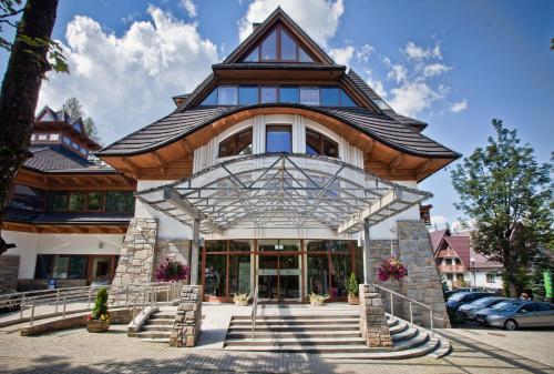 a large house with a gambrel roof at Hotel Crocus in Zakopane