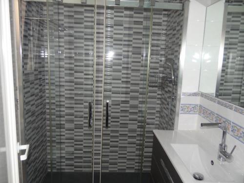 y baño con ducha de cristal con lavabo y aseo. en Apartamento en Vinaros, en Vinarós