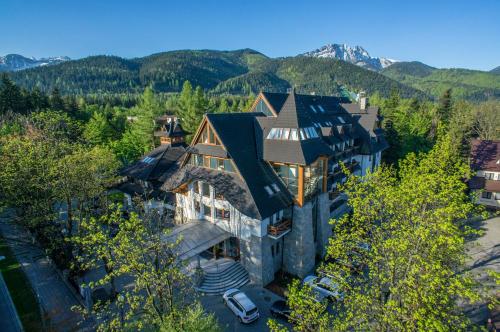 an aerial view of a large house in the mountains at Hotel Crocus in Zakopane