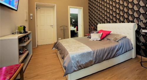 a bedroom with a large bed in a room at MYO Cagliari Charming House in Cagliari
