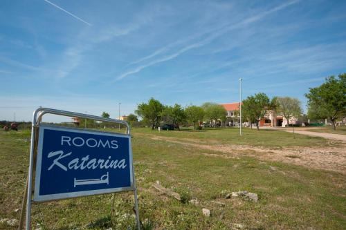 a blue road sign in the middle of a field at Rooms Katarina in Lozovac