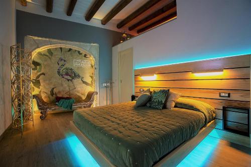 a bedroom with a large bed and a chair at MYO Cagliari Charming House in Cagliari