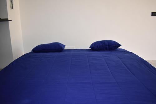 a blue bed with two pillows on top of it at Sofia Mare in San Felice Circeo