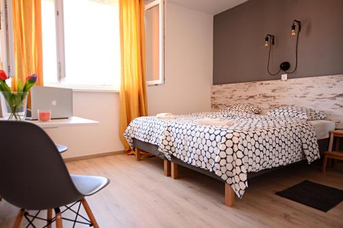 a small bedroom with a bed and a window at Nora Rooms in Zadar