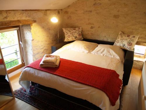 een slaapkamer met een bed in een kamer met een raam bij La Vayssade - Gîte de Charme - 6 pers - Piscine Jacuzzi & Truffes in Lalbenque