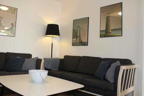 a living room with a couch and a table at Odense Apartments in Odense