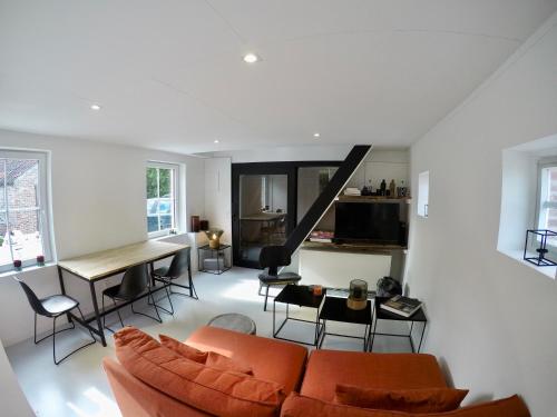 a living room with a couch and a table at Tidal Nest - North Sea Stays in Wenduine