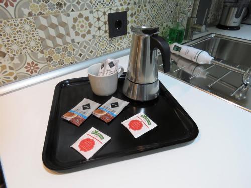 a black tray with a coffee maker on a kitchen counter at Living Sevilla Apartments H&eacute;rcules in Seville