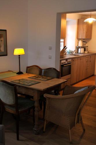 a kitchen with a wooden table with chairs and a dining room at Malerhaus am Kolbergarten in Bad Tölz