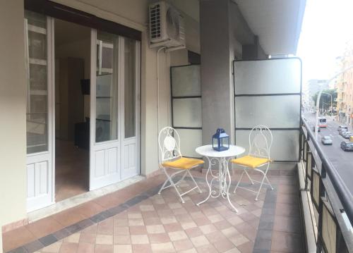 a balcony with two chairs and a table on a building at Affittacamere Easy Cagliari in Cagliari