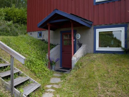 a red house with a red door on a hill at Prästgården i Funäsdalen in Funäsdalen