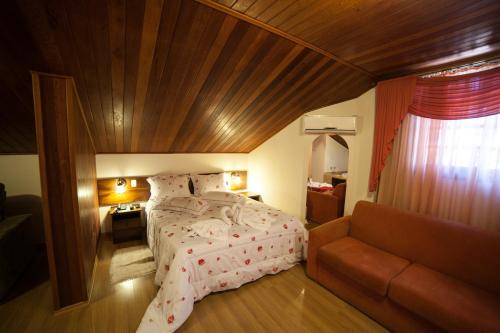 En eller flere senge i et værelse på Pousada Vollweiter