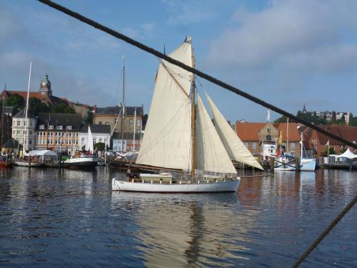 a sail boat in the water in a harbor at Fördefarm-Natura in Westerholz