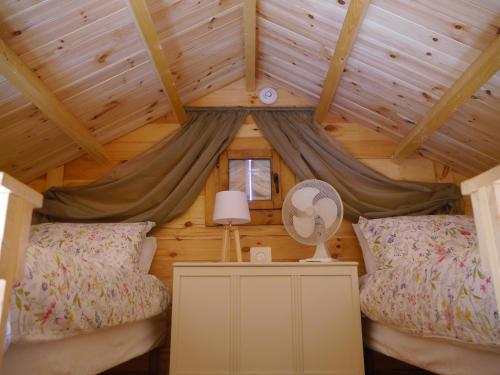 een slaapkamer in een blokhut met 2 bedden bij Le Chalet in Prémian