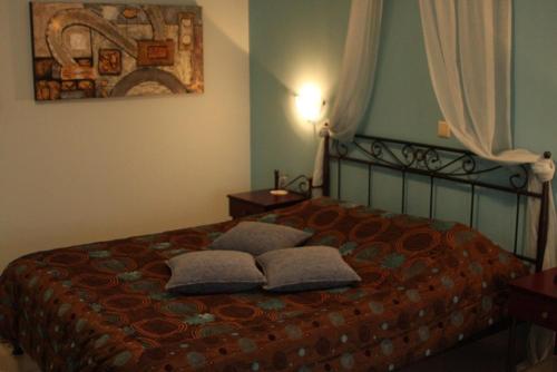 a bedroom with a bed with two pillows on it at Lozitsi in Veria