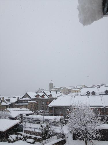 a city covered in snow with buildings and trees at Tierra de Biescas in Biescas