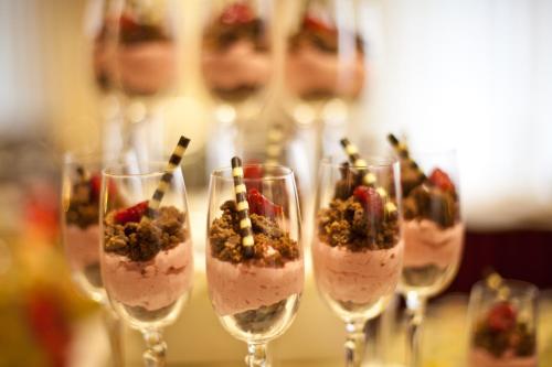 a row of wine glasses with dessert in them at NOVINA HOTEL Südwestpark in Nürnberg