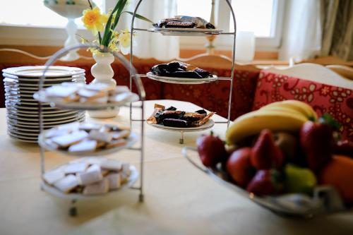 a table topped with plates of food and desserts at Hotel Burgwirt in Deggendorf