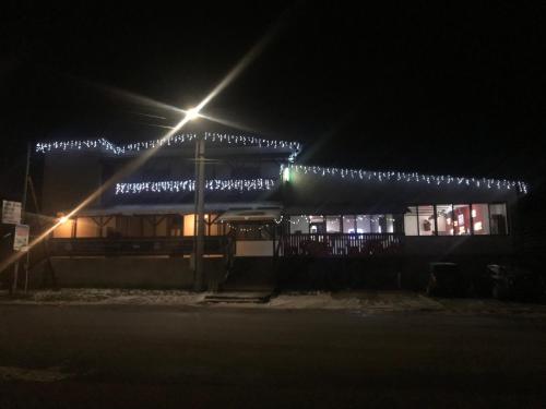 a building decorated with christmas lights at night at Penzión Music in Nižný Slavkov