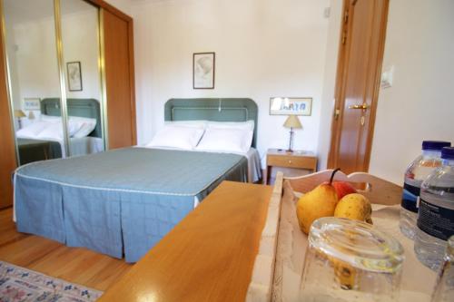 a bedroom with a bed and a table with fruit on it at Casa do Lago in Amares