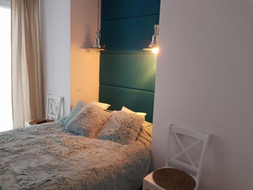ヤストシェンビャ・グラにあるAmko Style Apartamenty Róża Wiatrów Willa Nordのベッドルーム1室(緑のヘッドボード付きのベッド1台付)