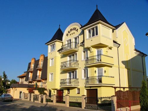a large yellow building with a black roof at Villa Sedina in Rewal
